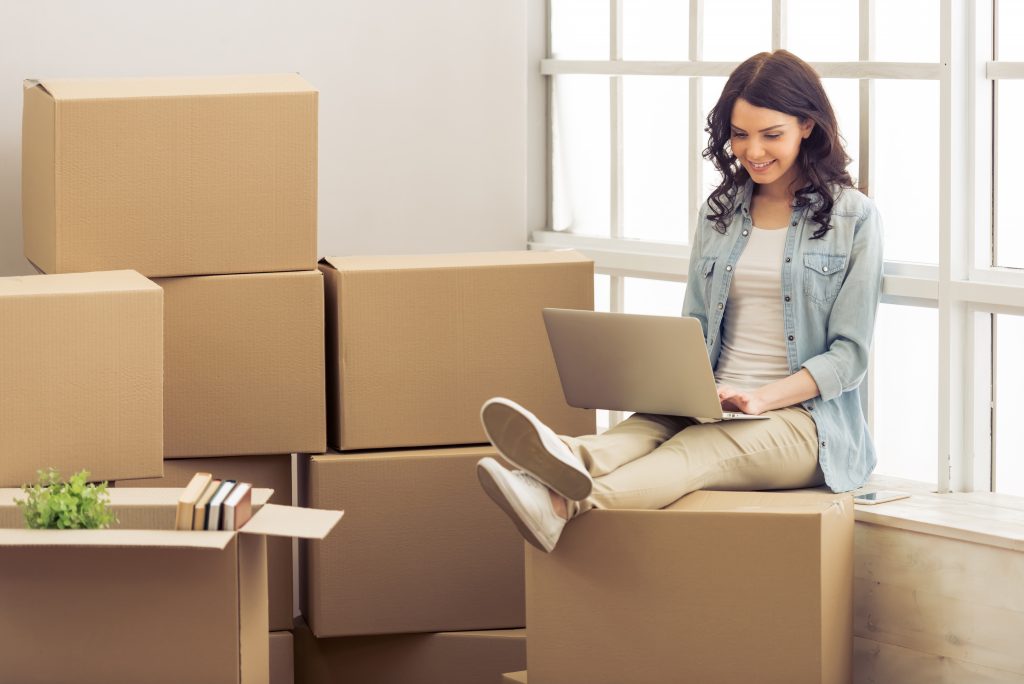 Student sitting on a box after move-in