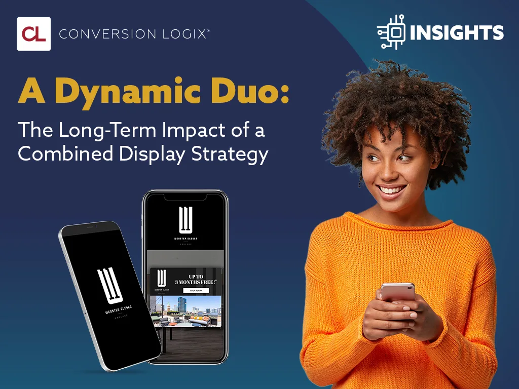 woman wearing an orange sweater holding a cell phone looking at an image of two cell phone with display ads on the screen with an insights icon